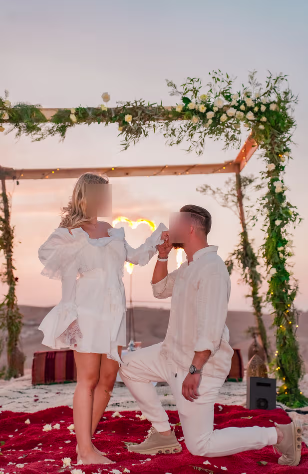 Romantic sunset proposal with an illuminated love sign in the Agafay Desert